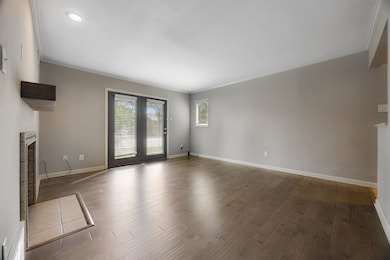 Unfurnished living room featuring a tiled fireplac