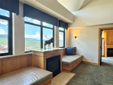 A daybed flanks each side of the fireplace. The vi