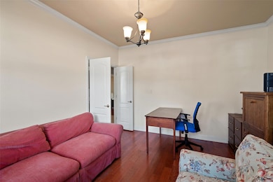 Living room featuring crown molding, a chandelier