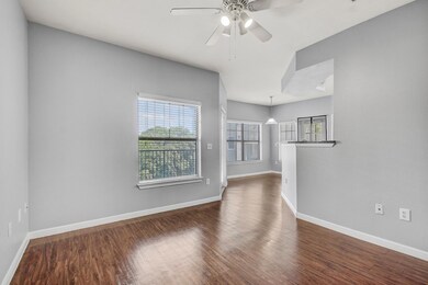 Spare room featuring baseboards, dark wood-style 