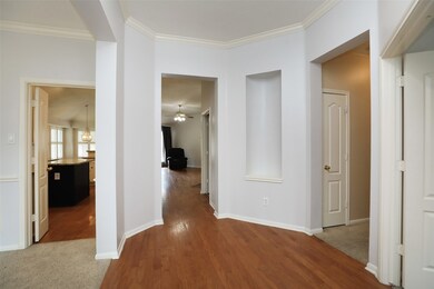 Inside find a practical split floorplan with high ceilings, art niche, and beautiful natural light.