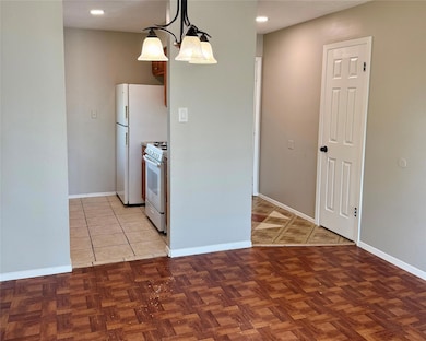 Kitchen featuring white appliances, recessed ligh