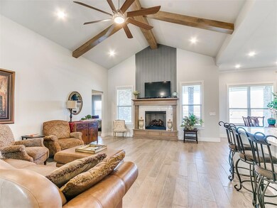 Living room featuring ceiling fan, a tile fireplac