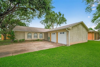 This charming single-story home
features a brick exterior with a two-car
garage and a well-maintained front
lawn. Mature trees provide shade and
add curb appeal.