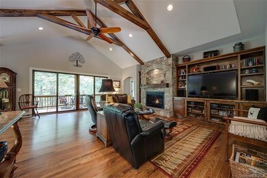 Inviting living room with stone fireplace, wood fl