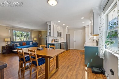 Dining room with sink, dark hardwood / wood-style 