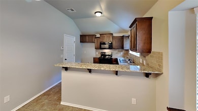 Kitchen featuring black appliances, a sink, a peni
