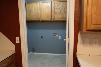 Laundry area featuring light tile patterned floori