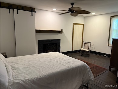 Bedroom featuring wood finished floors, recessed l