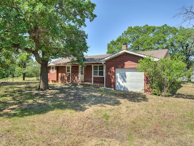 Ranch-style house featuring a front yard, a shingled roof, a chimney, and an attached garage