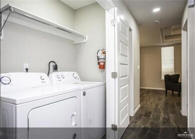 Laundry room with independent washer and dryer, baseboards, dark wood-style flooring, and recessed lighting