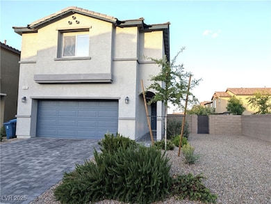 View of front of house with stucco siding, a garag