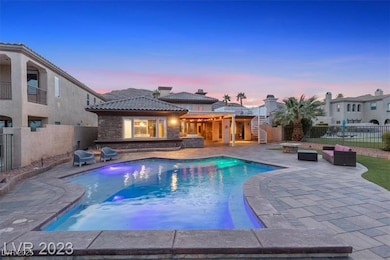 Pool at dusk with a fenced backyard, a patio area,