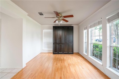 Unfurnished room with crown molding, ceiling fan,