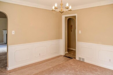 Formal dining room with wainscoting and crown mold