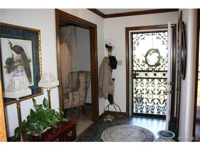 Foyer with decorative storm dooe and crown mouldin