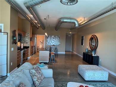 Living room with concrete flooring and baseboards
