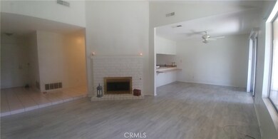 View from living room to entry door and dining room.  Brick fireplace have been painted.