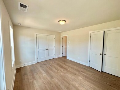 Unfurnished bedroom featuring light wood finished floors and baseboards