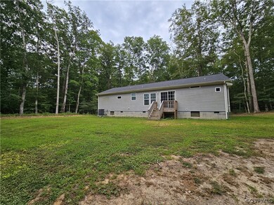 Rear view of property featuring a lawn