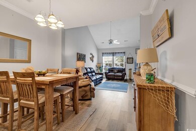 Dining space with ceiling fan with notable chandel