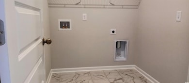 Clothes washing area featuring washer hookup and e