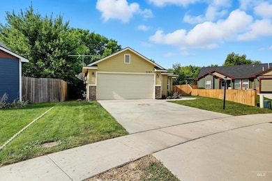 View of front facade featuring concrete driveway, stone siding, and an attached garage