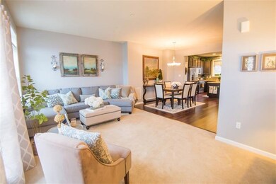 Additional view of living room opening into dining