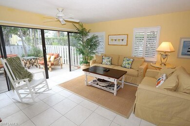 Living area featuring a ceiling fan, plenty of natural light, and light tile patterned flooring