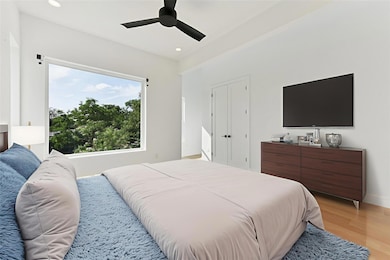Bedroom featuring light wood-type flooring, reces