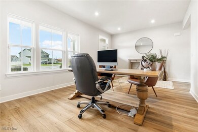 Office space with recessed lighting and light wood finished floors