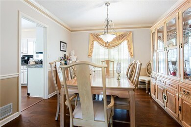 Dining area featuring  dark wood-style floors, and
