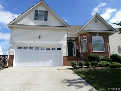 Front view of  home with brick details and large d