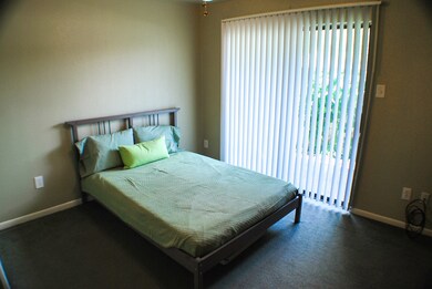 Second bedroom with sliding glass doors to patio.