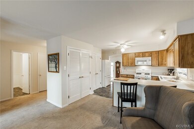 Living room opens to kitchen with breakfast bar