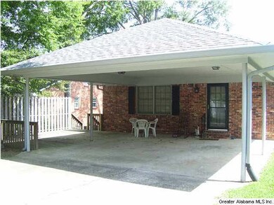Back view with two car carport and deck