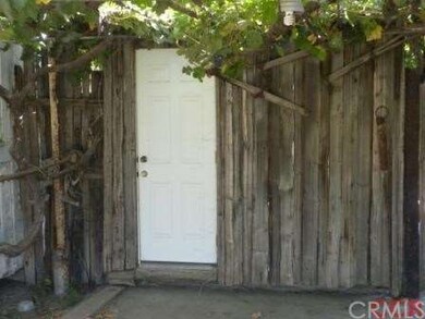 Walk-in cold box behind the rock BBQ, between the 