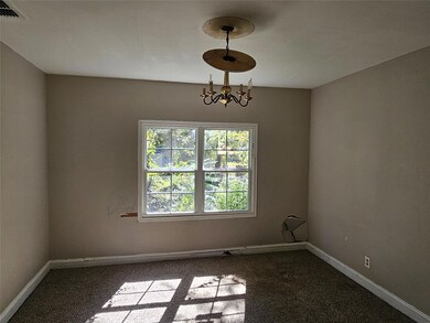 Unfurnished room featuring a notable chandelier an