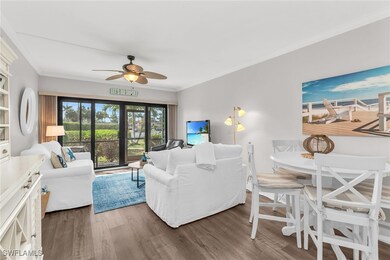 Living room with a ceiling fan, wood finished floo