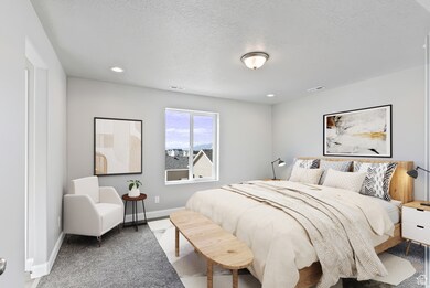 Bedroom with a textured ceiling, light colored carpet, and recessed lighting