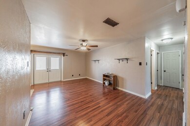 Empty room with dark wood-type flooring, french do