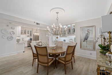 Dining room featuring light hardwood / wood-style flooring, a chandelier, and ornamental molding