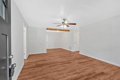 Open family room with new flooring, front door and fixtures