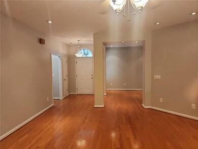 Entrance foyer featuring a chandelier, recessed lighting, baseboards, and wood finished floors