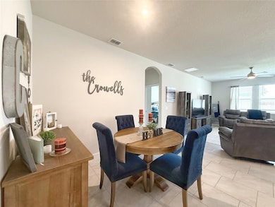 Dining room and Living room with extra tall doors and view of fenced in back yard. Ceramic tile flooring on offset set, 5 1/4” baseboards