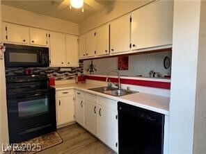 Kitchen with white cabinets, a sink, ceiling fan,