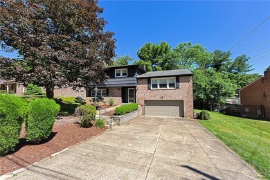 2 Car Garage with a Cement Driveway that Provides Off-Street Parking