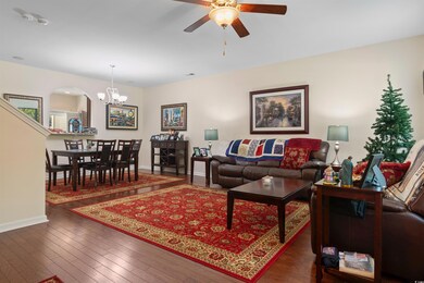 Living room featuring ceiling fan with notable cha