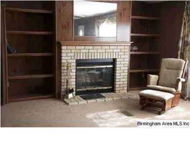 Double wide modular home has fireplace in open gre