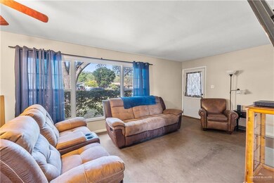 Living room with ceiling fan and carpet